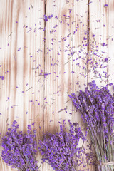 three lavender dried flowers bouquets on wooden desk, top view