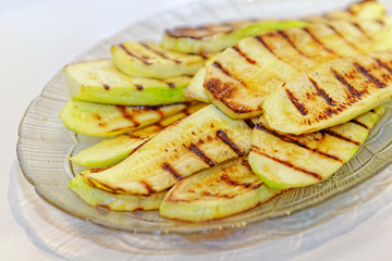 Close up grilled zucchini on plate. Macro of a vegetable. Shallow depth a field