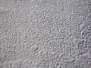 Beautiful white snow texture, formed by the winter wind. Waves and Dunes