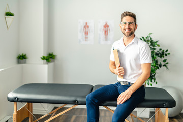 A Modern rehabilitation physiotherapy man at work - obrazy, fototapety, plakaty