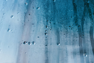 Condensation on the clear glass window. Water drops. Rain. Abstract background texture