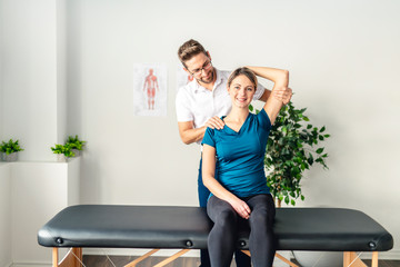 A Modern rehabilitation physiotherapy man at work with woman client
