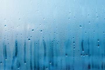 Condensation on the clear glass window. Water drops. Rain. Abstract background texture - obrazy, fototapety, plakaty