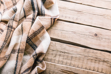 Obraz premium Plaid wool plaid on old wooden background