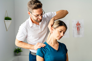 A Modern rehabilitation physiotherapy man at work with woman client - obrazy, fototapety, plakaty