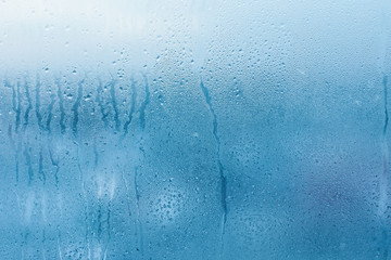 Condensation on the clear glass window. Water drops. Rain. Abstract background texture