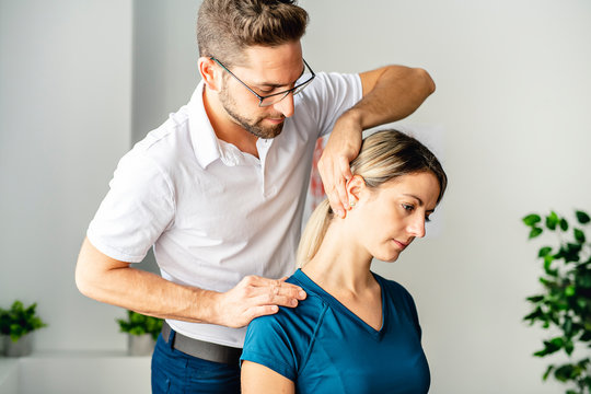 A Modern rehabilitation physiotherapy man at work with woman client