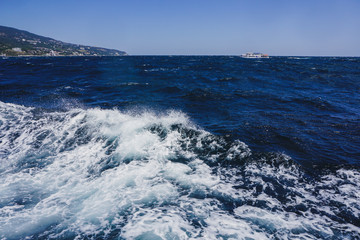 Fototapeta premium Yalta, Crimea, Russia. Black sea surface with white foam.