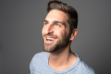 Obraz premium A Handsome man standing over dark grey background Portrait man concept.