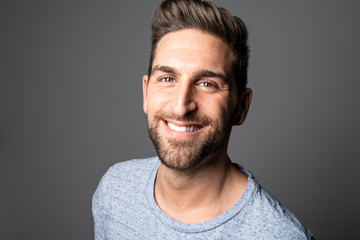 Obraz premium A Handsome man standing over dark grey background Portrait man concept.