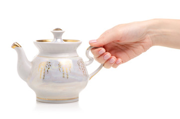 Tea pot in hand on a white background. Isolation