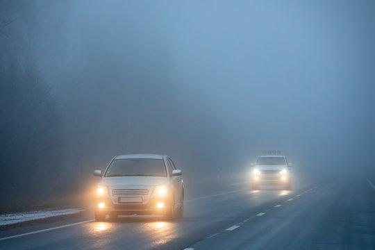 Cars on the road in the fog