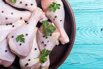 Raw chicken legs with spices and parsley. Food background
