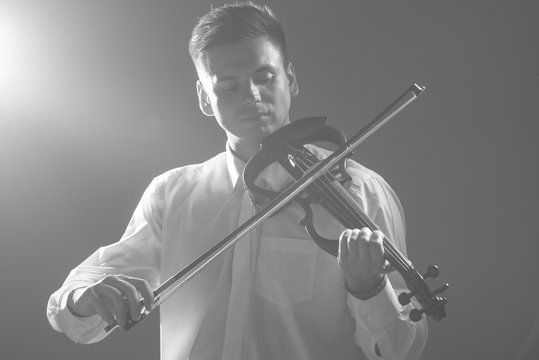 The musician plays the electronic violin. Violin close up. 
