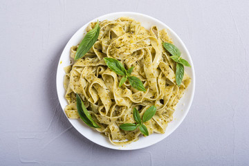 Pasta tagliatelle with green sauce pesto . Italian food background