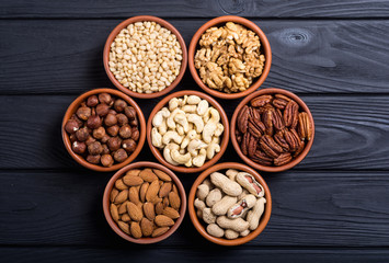 Mix of nuts : Pistachios, almonds , walnuts , pine nut , hazelnuts and cashew . Snack in bowl backgrond