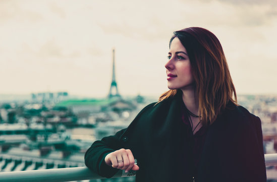 portrait of beautiful young woman looking at the splendid view of wonderful Paris background