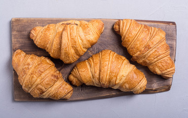 Croissants on wooden background