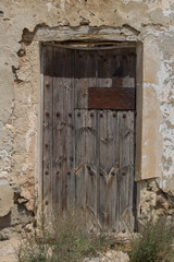 old wooden door, old door, old wood and metal door in Spanish village