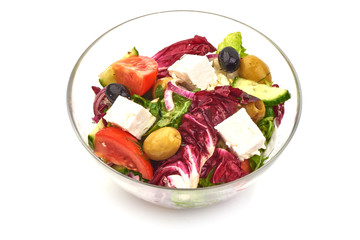 Fresh vegetable salad with feta cheese, lettuce, cherry tomatoes, olives and pepper, isolated on white background
