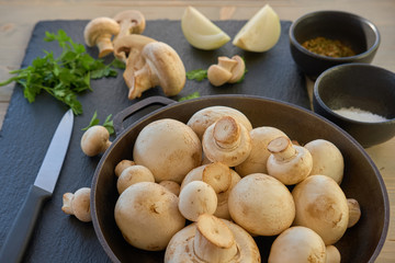 Champignon mushrooms in a cast iron skillet