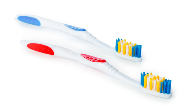 Pair of white blue and white red toothbrush isolated on white background, close up.