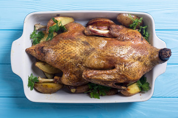 Homemade baked duck with potatoes and apple . Christmas food