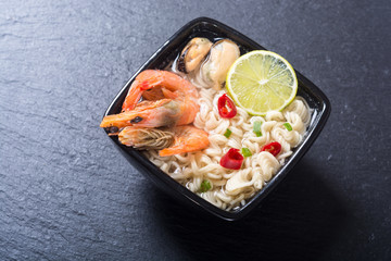 Instant noodles soup with shrimps and mssels . Asian food