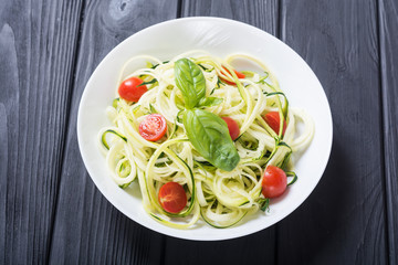 Zucchini pasta noodles with tomatoes . Healthy vegetarian food