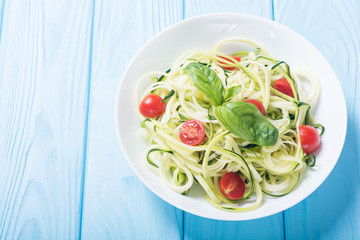 Zucchini pasta noodles with tomatoes . Healthy vegetarian food