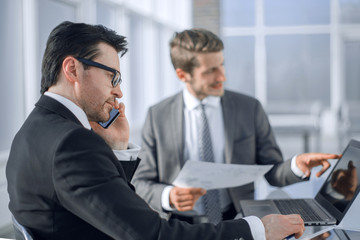 employees use a laptop to check new data.