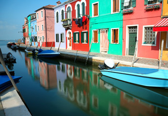 Fototapeta na wymiar Houses on the island of Burano near Venice in Italy and the refl