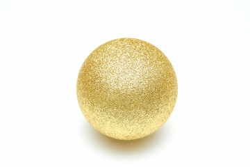Golden shiny christmas ball isolated on a white background. Decorative toy.