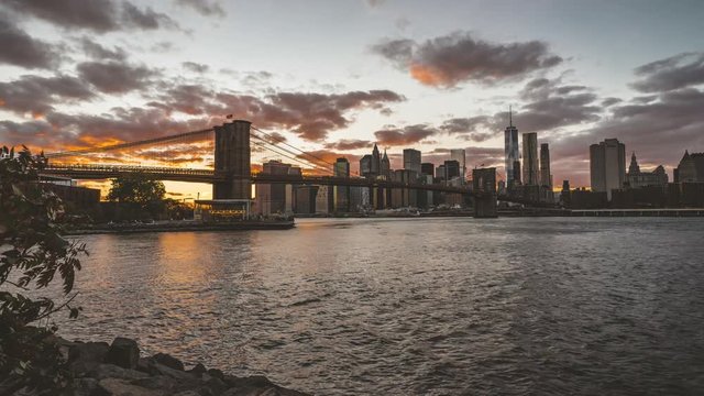 4k Timelapse movie film clip of New York City Manhattan, day to night transition with financial district skyline, cityscape at Brooklyn bridge park at day during sunset, with buildings, skyscrapers