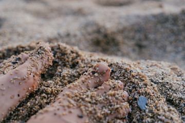 Woman feet in sand. Summer vacation concept