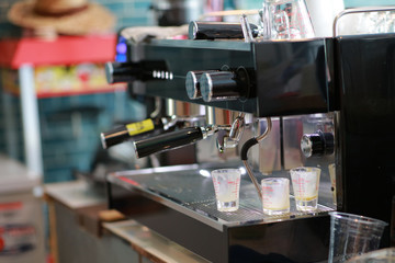 Barista making a espresso with a classic Italian coffee machine