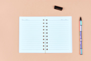 Notepad for text on a pastel color table with a copy. The concept of education and office.