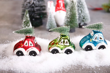 drei autos mit weihnachtsbäumen im schnee