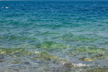 vivid blue sea shore water with waves background surface 