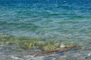 vivid blue sea shore water with waves background surface 