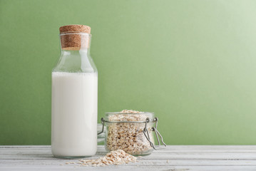 Bottle of  oat milk with oat flakes