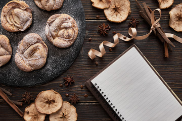 Fototapeta premium notebook, muffins on black plate
