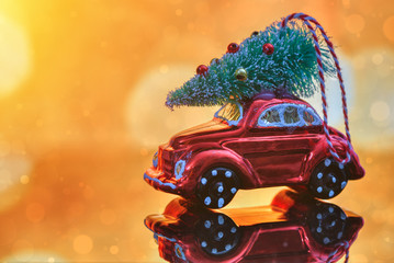 Christmas tree on toy car. Christmas holiday celebration concept