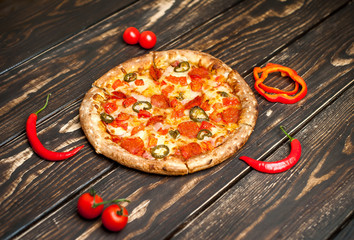 pizza on wood table with ingredients