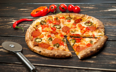pizza on wood table with ingredients