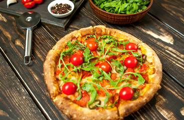 pizza on wood table with ingredients