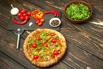 pizza on wood table with ingredients
