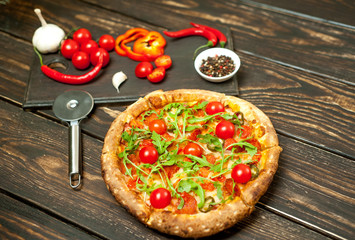 pizza on wood table with ingredients