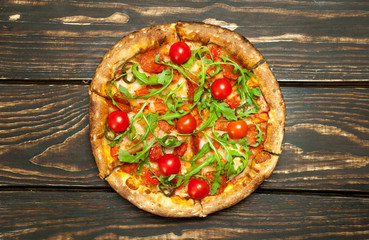 pizza on wood table with ingredients