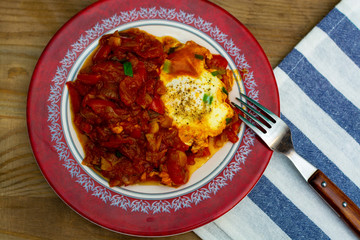 eggs in tomato sauce in a plate - Shakshuka